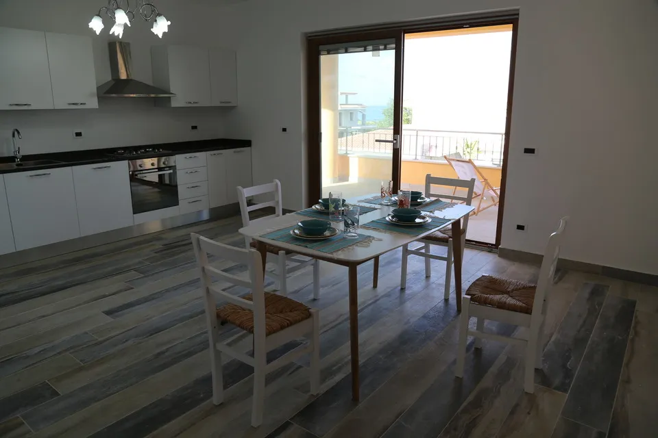 Kitchen with the door open to the sunny balcony