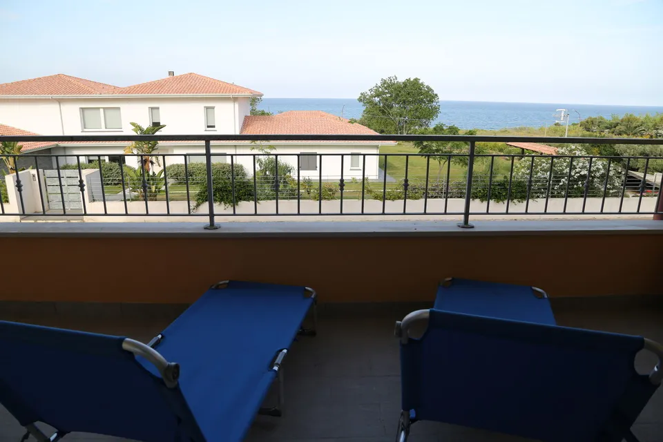 Calm view over the sea from the balcony lounge chairs