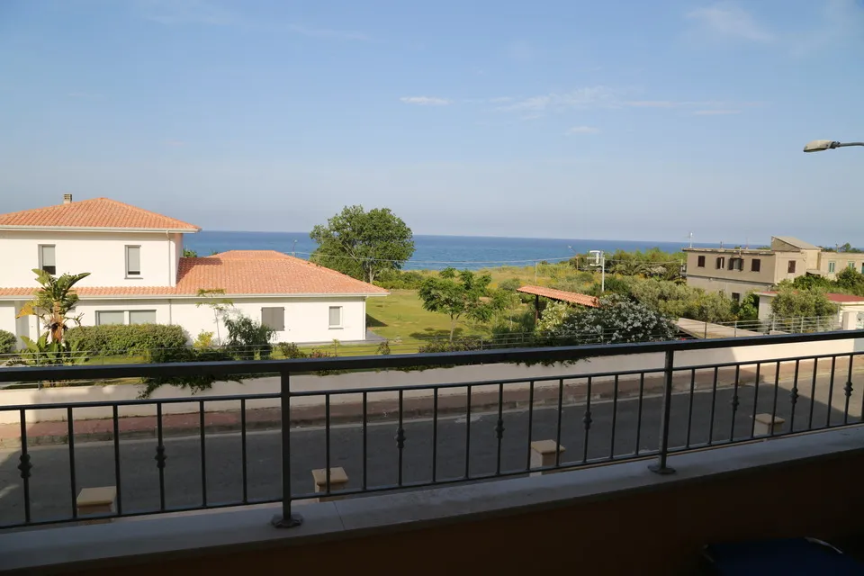 Close-up view of the sea over the balcony railing
